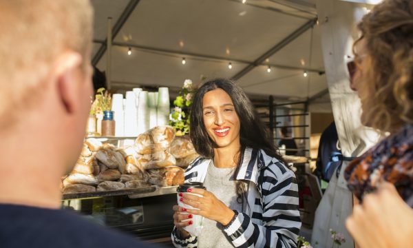 Friends buying drink and bread during festival
